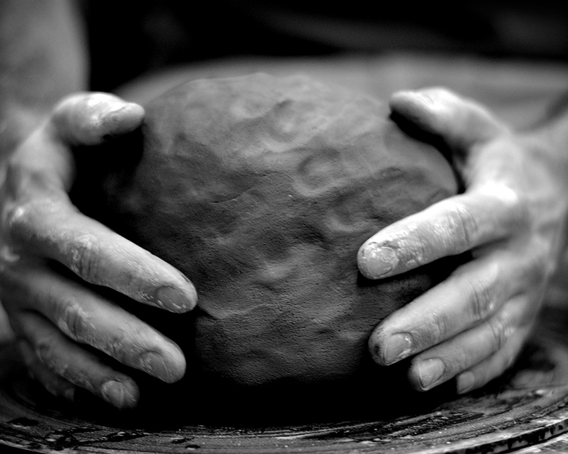 Hands holding a ball of clay
